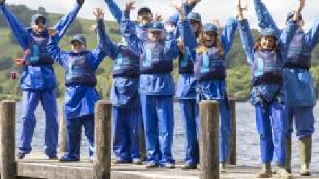 Group with their hands in the air on the pontoon at the 2021 Water Park Under 18s return trip