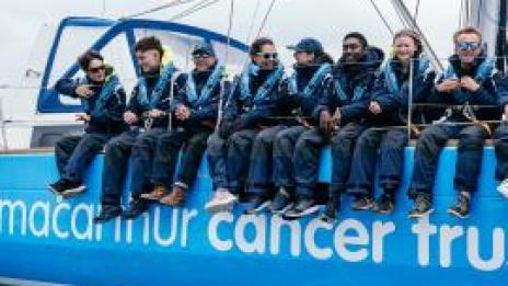 Young people sitting on the side of Solent Hero with Ellen MacArthur during Round the Island Race