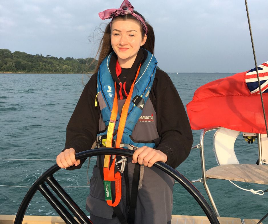 Alys helming the boat on her Trust trip