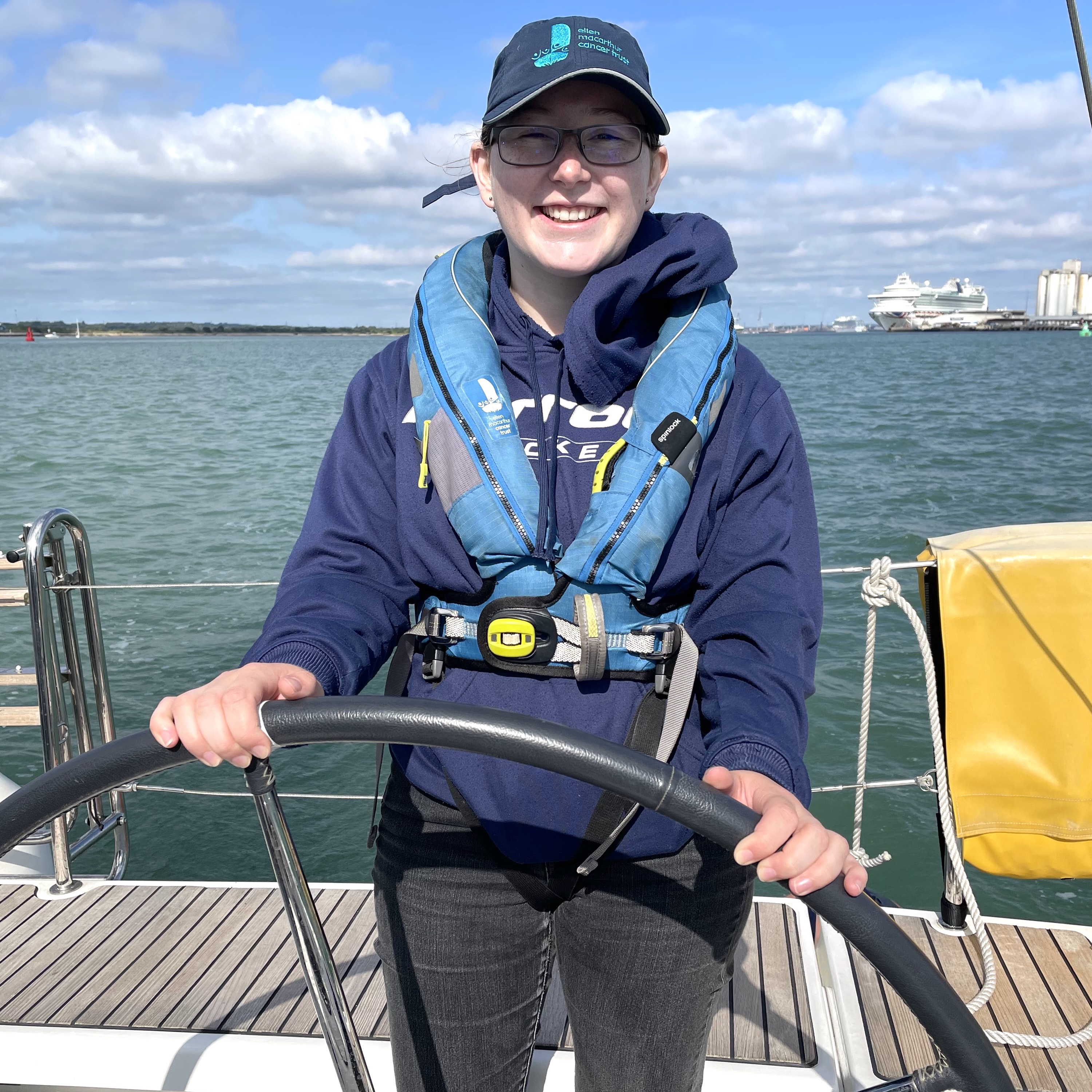 Laura Warren smiling at the helm