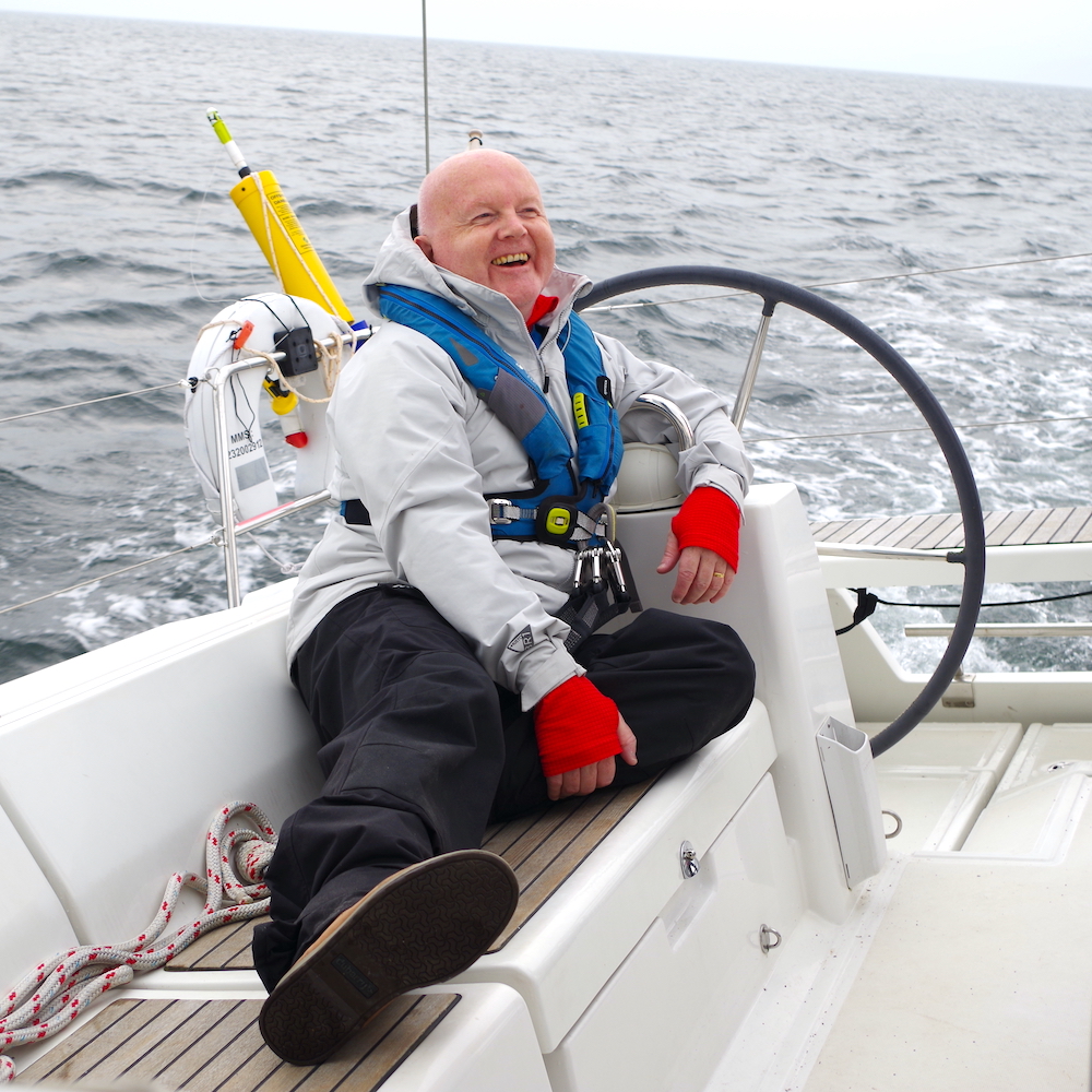 Dr Dave Hobin laughing as he sails in Largs in September 2021