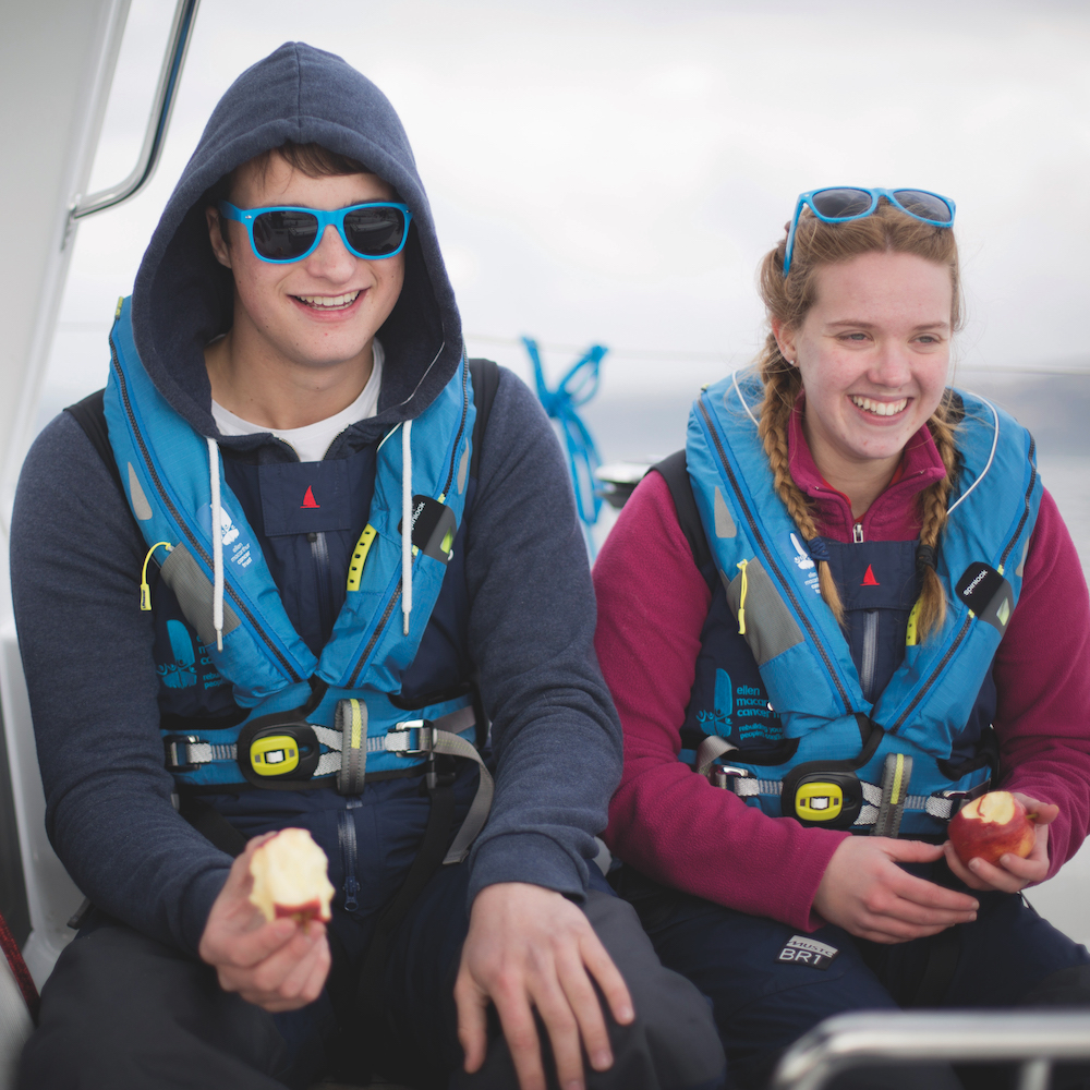 Adam Bromley (left) and Danielle Clapcott (right), Youth Advisory Group members, smiling on a trip