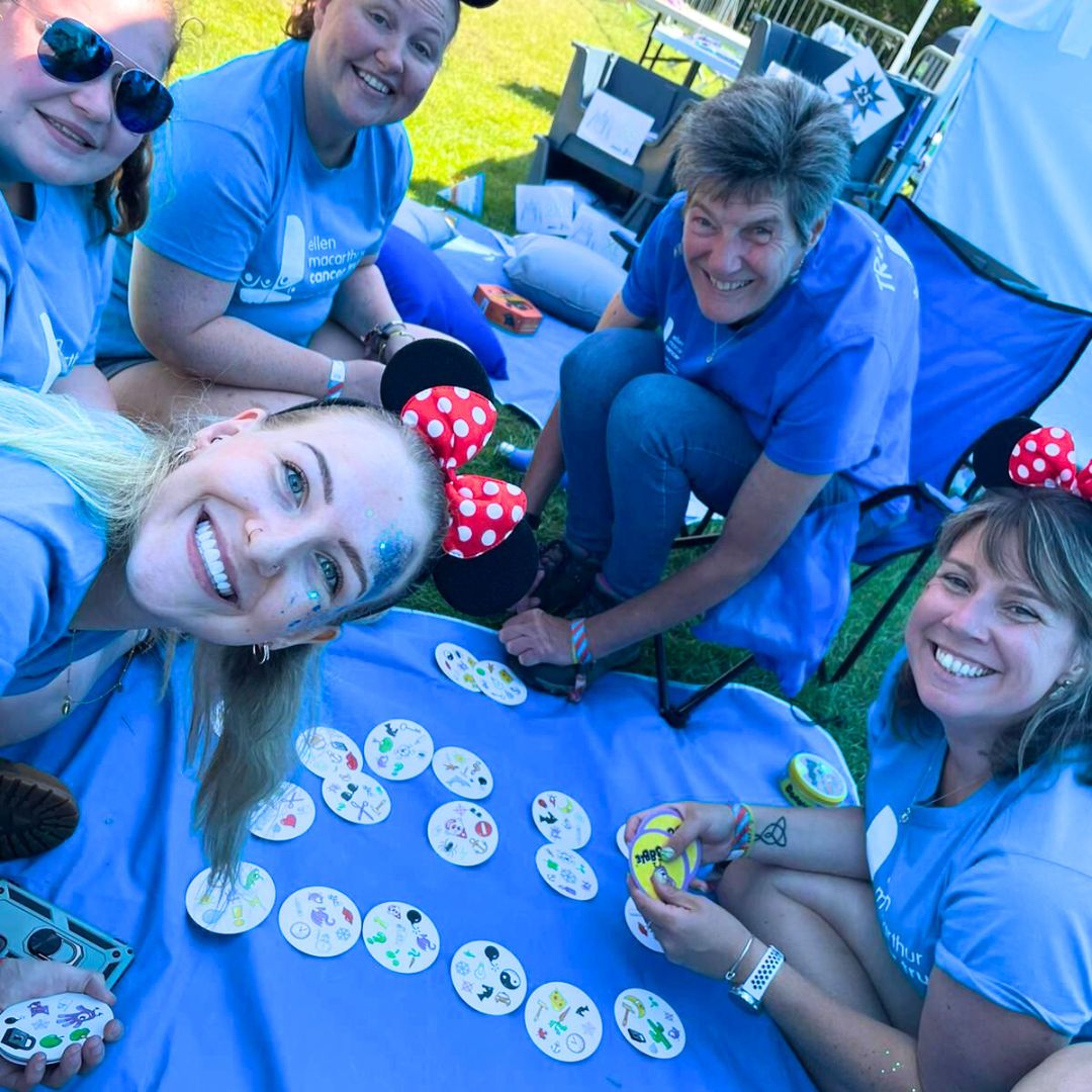 The Trust fundraising team sat round in our blue marquee playing Dobble at Camp Bestival
