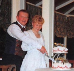 Amanda and John Seddon cut the cake on their wedding day